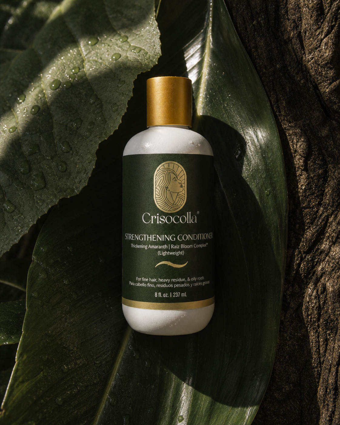 Crisocolla strengthening conditioner bottle on a leafy background