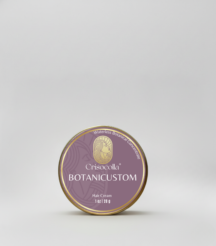 A round gold tin of Crisocolla BotaniCustom Waterless Botanical Concentrate Hair Cream with a muted heather purple label and gold logo.